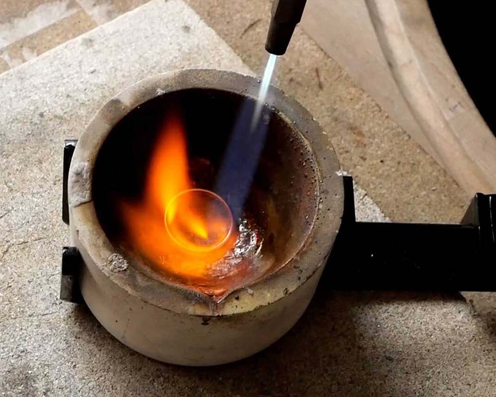 Alliance dans un creuset sous le chalumeau